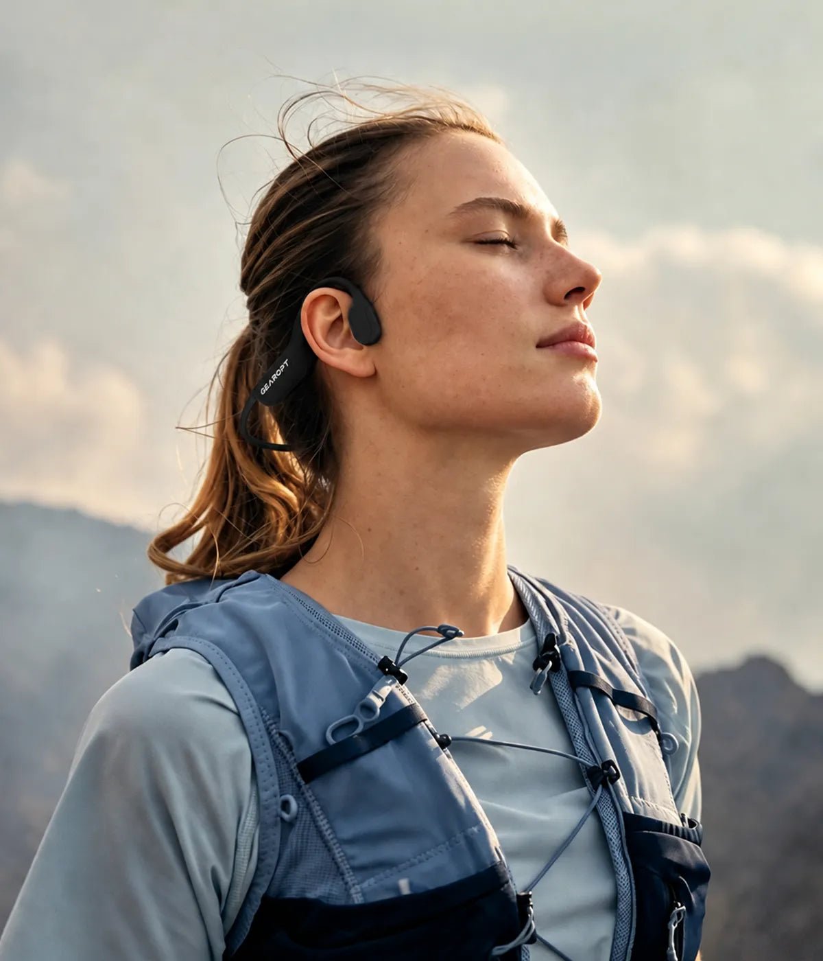Woman wearing GWS CURRENT headphones outdoors